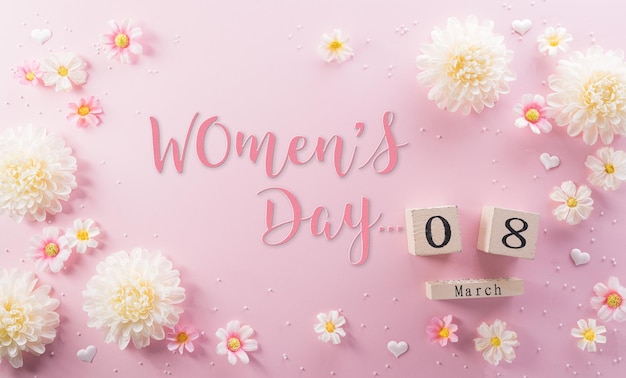 Happy Womens Day decoration concept made from flower and wooden calendar on pink pastel background