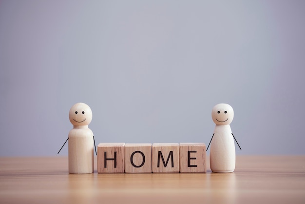 Happy wood family person model a smiley with word home on wood cube table background