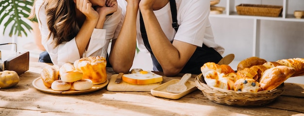 Happy young adult couple making breakfast and drinking coffee together in cozy home kitchen in morning at home Preparing meal and smiling Lifestyle leisure and Love concept