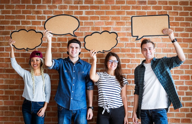 Happy young adults holding up copyspace placard thought bubbles