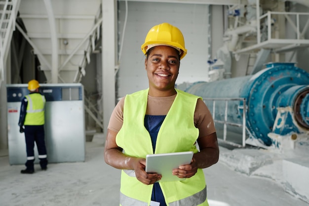 Happy young african american woman with tablet standing in front of camera