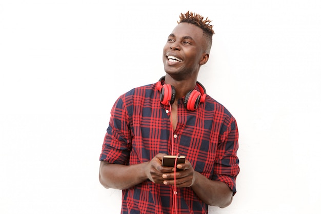 Happy young african man with headphones and mobile phone 