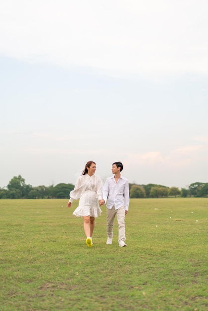 Happy young Asian couple in bride and groom clothing