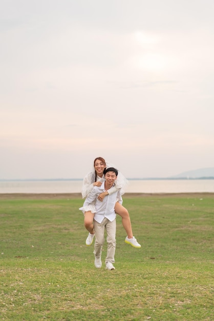 Happy young Asian couple in bride and groom clothing