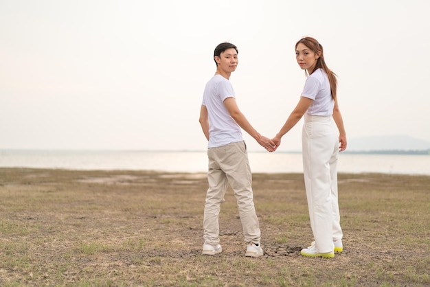 Happy young Asian couple in bride and groom tshirt