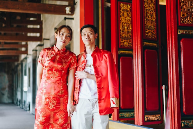 Happy young Asian couple in Chinese traditional dresses