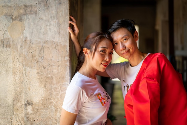 Happy young Asian couple in Chinese traditional dresses