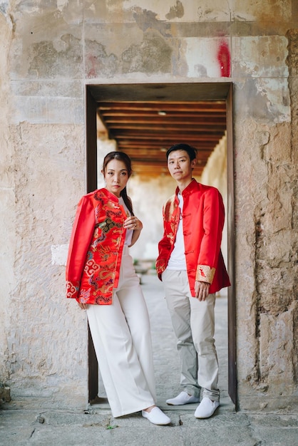 Happy young Asian couple in Chinese traditional dresses