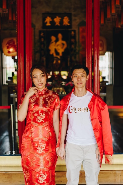 Happy young Asian couple love in Chinese traditional dresses - Red is the main color of the traditional festive that including wedding in China.