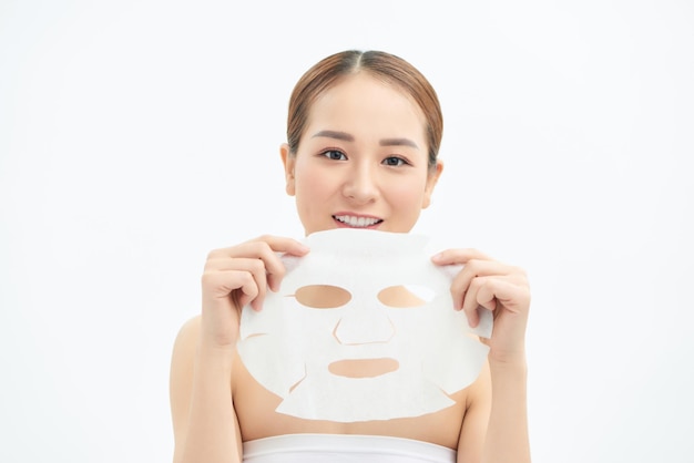 Happy young Asian girl holding face mask isolated on white background