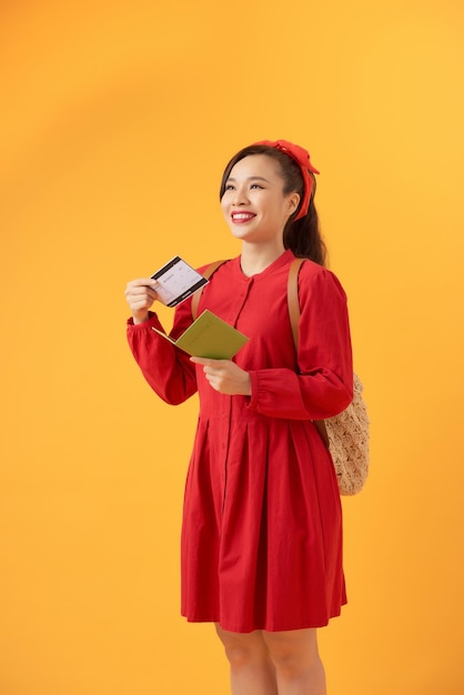 Happy young Asian woman holding flight ticket passport and ready to travel