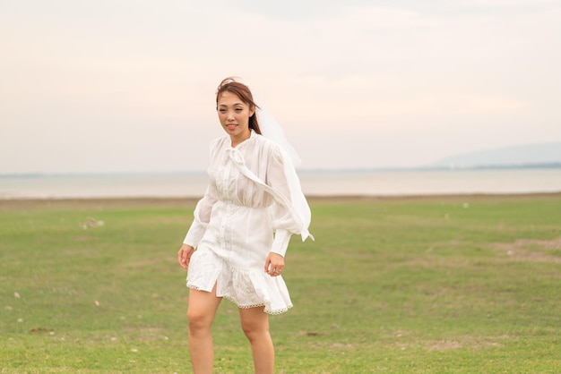 Happy young Asian women in bride clothing with veil