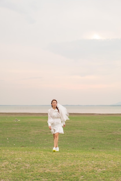 Happy young Asian women in bride clothing with veil