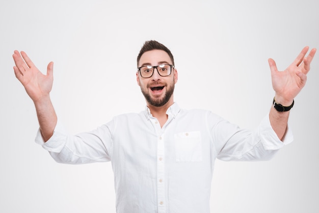 Happy young bearded man gesturing with hands