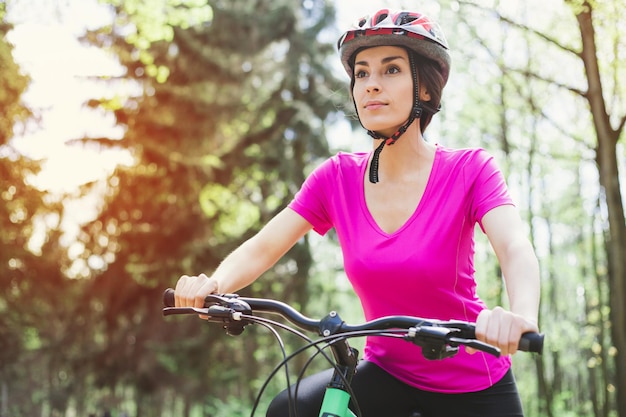 Happy Young Beautiful Woman Riding Sport Mountaine Bicycle in Forest outside Healthy Lifestyle Sport and Strong