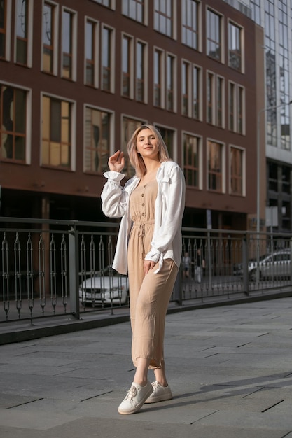 Happy young beautiful woman walking on the street Image of beautiful stylish woman