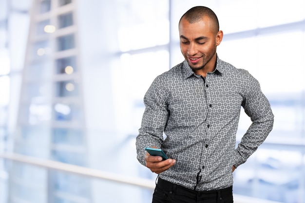 Happy young black african man with cell phone