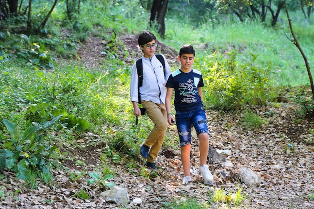 Happy young boy friends on a camping trip summer background