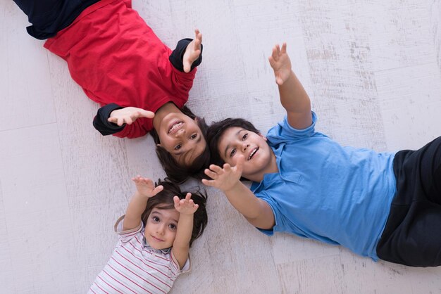 happy young boys having fun on the floor in a new modern home