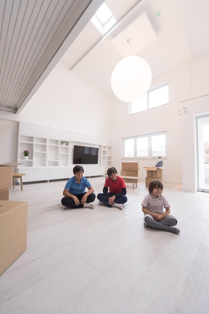 happy young boys having fun on the floor in a new modern home