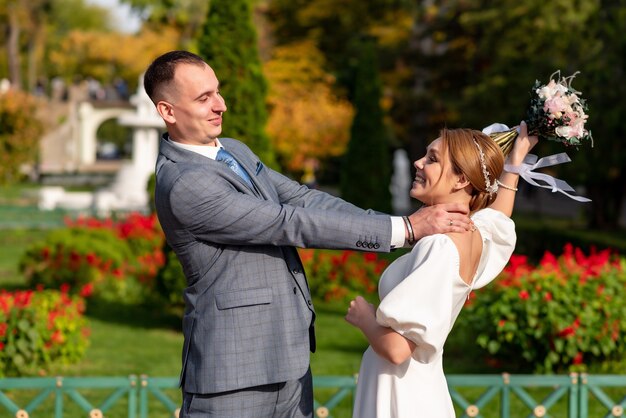 Happy young bride and groom on their wedding day A man makes a woman laugh