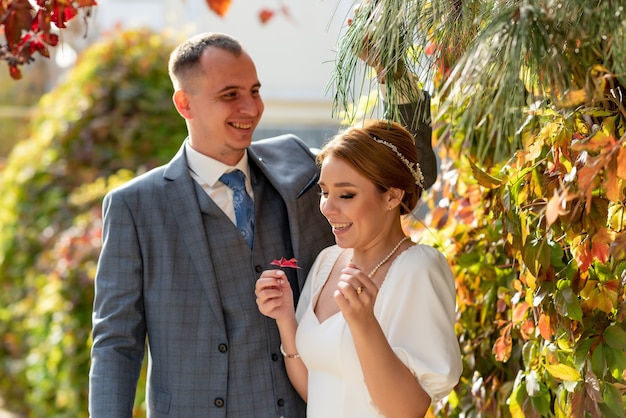 Happy young bride and groom on their wedding day A man makes a woman laugh