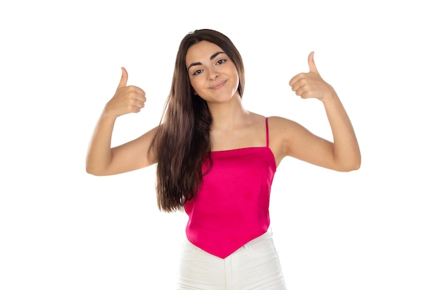 Happy young brunette girl saying Ok with her thumbs