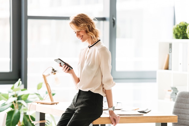 Happy young business woman in office