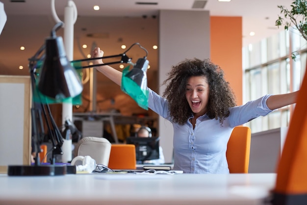 happy young  business woman with curly hairstyle in the modern office