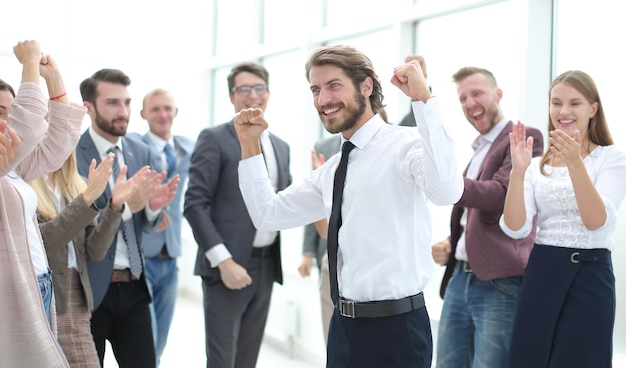 Happy young businessman on business team background