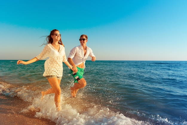 Happy young couple enjoying the sea