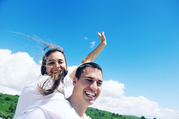 happy young couple have fun and relax  on the beach