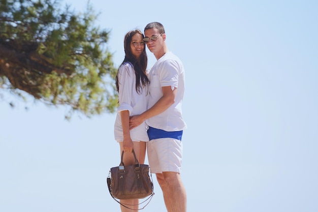 happy young couple have fun and relax  on the beach