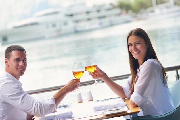 happy young couple having lanch at beautiful restaurant on the beach