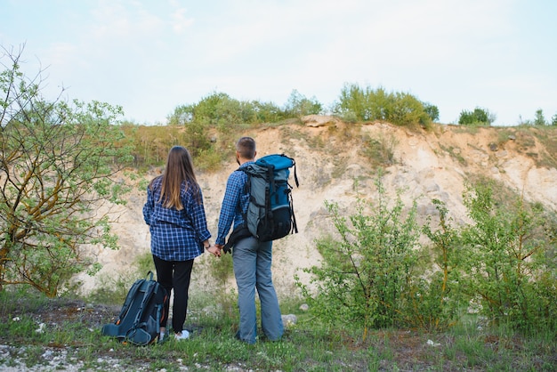 Happy young couple hiking in mountain