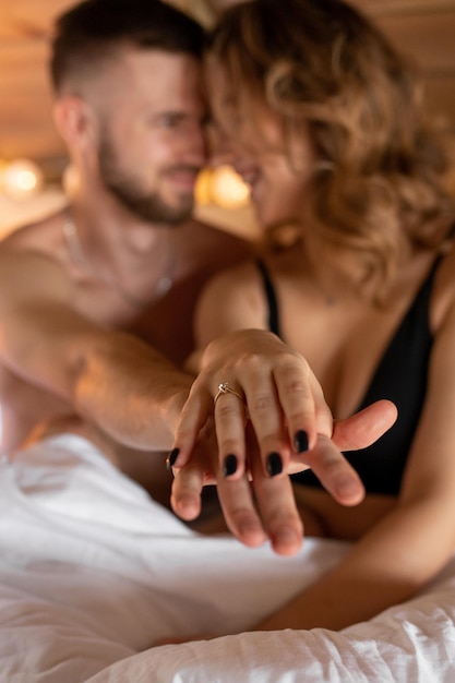 Happy young couple holding out their hands demonstrates engagement ring concept of engagement marria