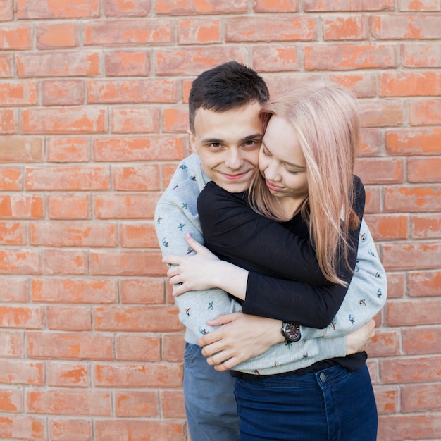 Happy young couple hugging and smiling.