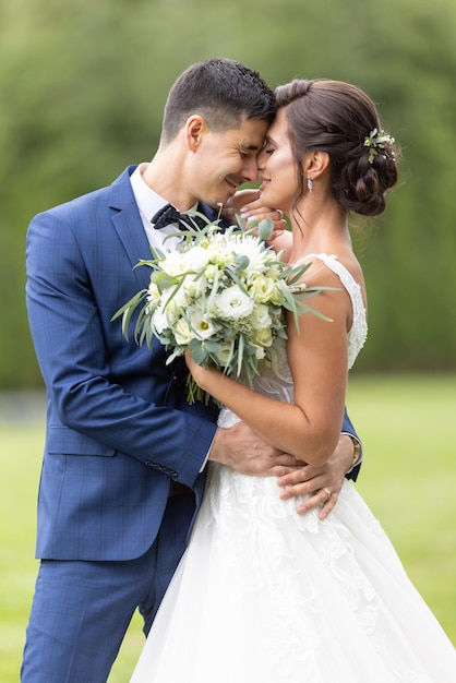 Happy young couple just got married and hold each other in the arms with happiness