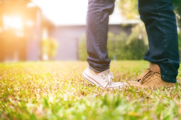 happy young couple in love walking in the park holding hands and kissing in the sunset