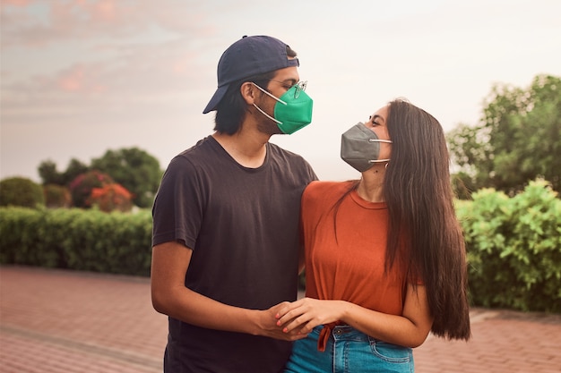 happy young couple in love walking together in the park at beautiful sunset