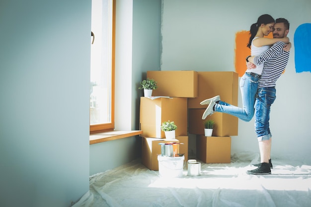 Happy young couple moving in new house young couple