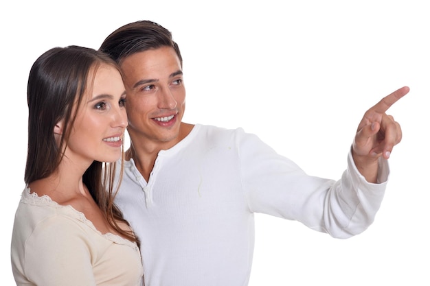 Happy young couple posing isolated on white background