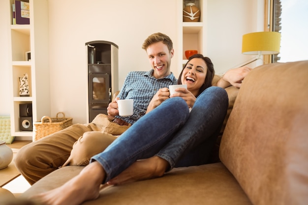 Happy young couple relaxing on the couch