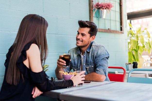 Happy young couple seating in a restaurant