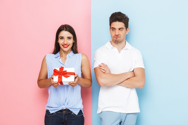 Happy young couple standing isolated