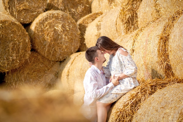 Happy young couple on straw, romantic people concept, beautiful landscape, summer season