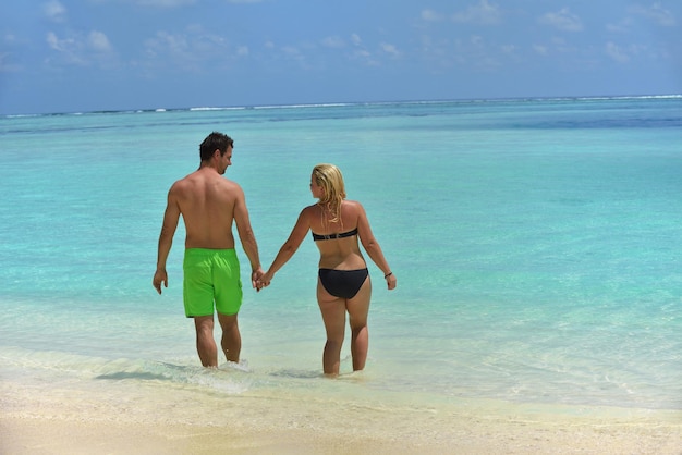 happy young  couple at summer vacation have fun and relax at beautiful sunny  day on beach