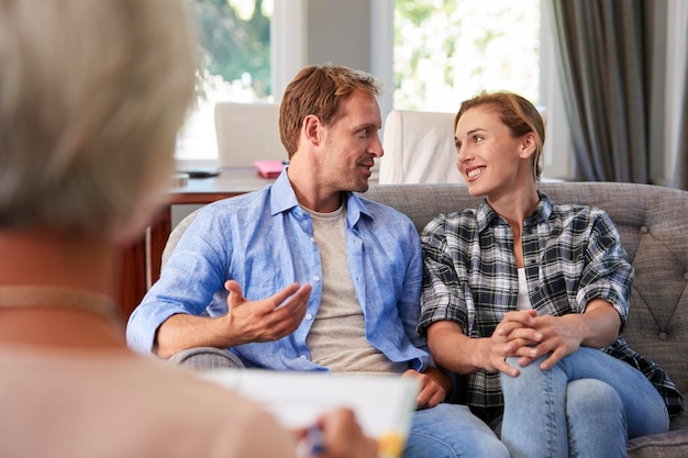 Happy young couple taking financial advice at home