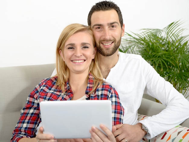 Happy young couple using digital tablet