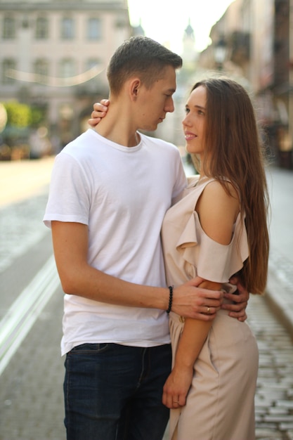 Happy young couple walking outdoors in old town